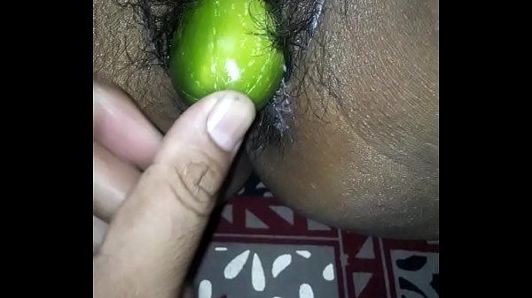 Girl fucks herself with cucumber